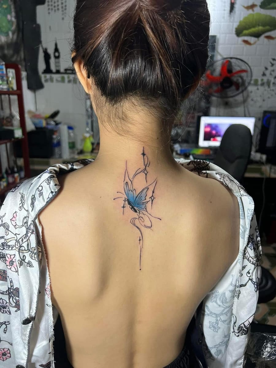 Fine-line watercolour butterfly tattoo