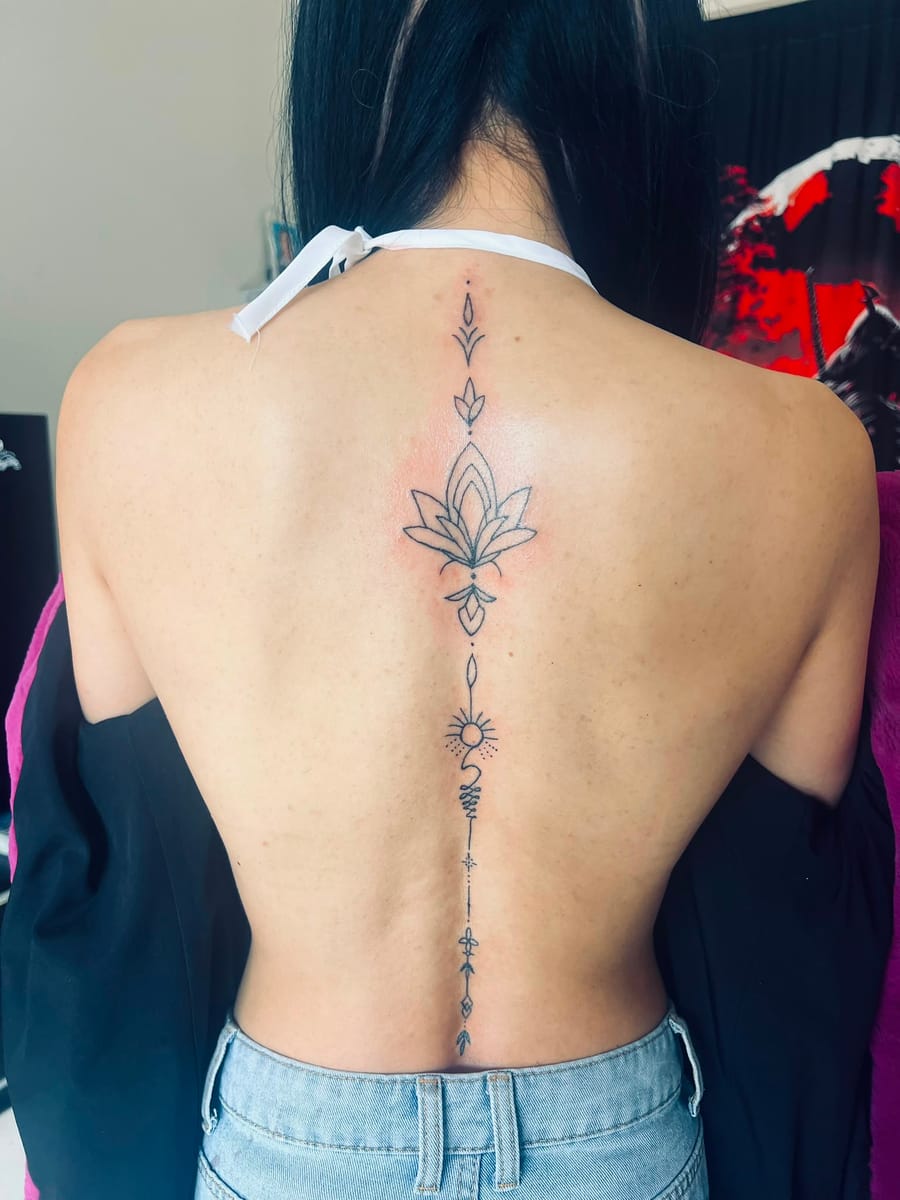 Ornamental spine tattoo