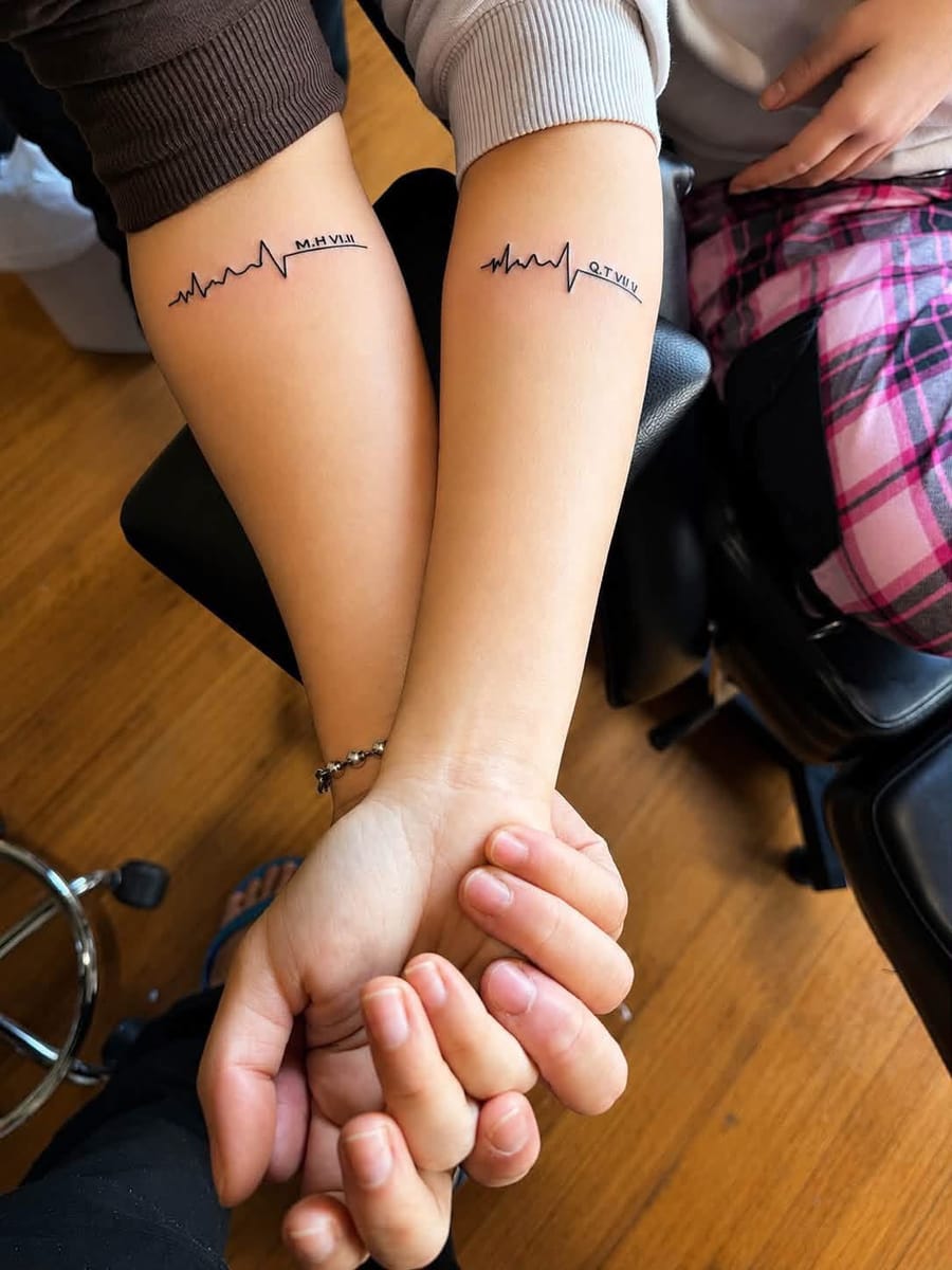 Matching couple heartbeat tattoos