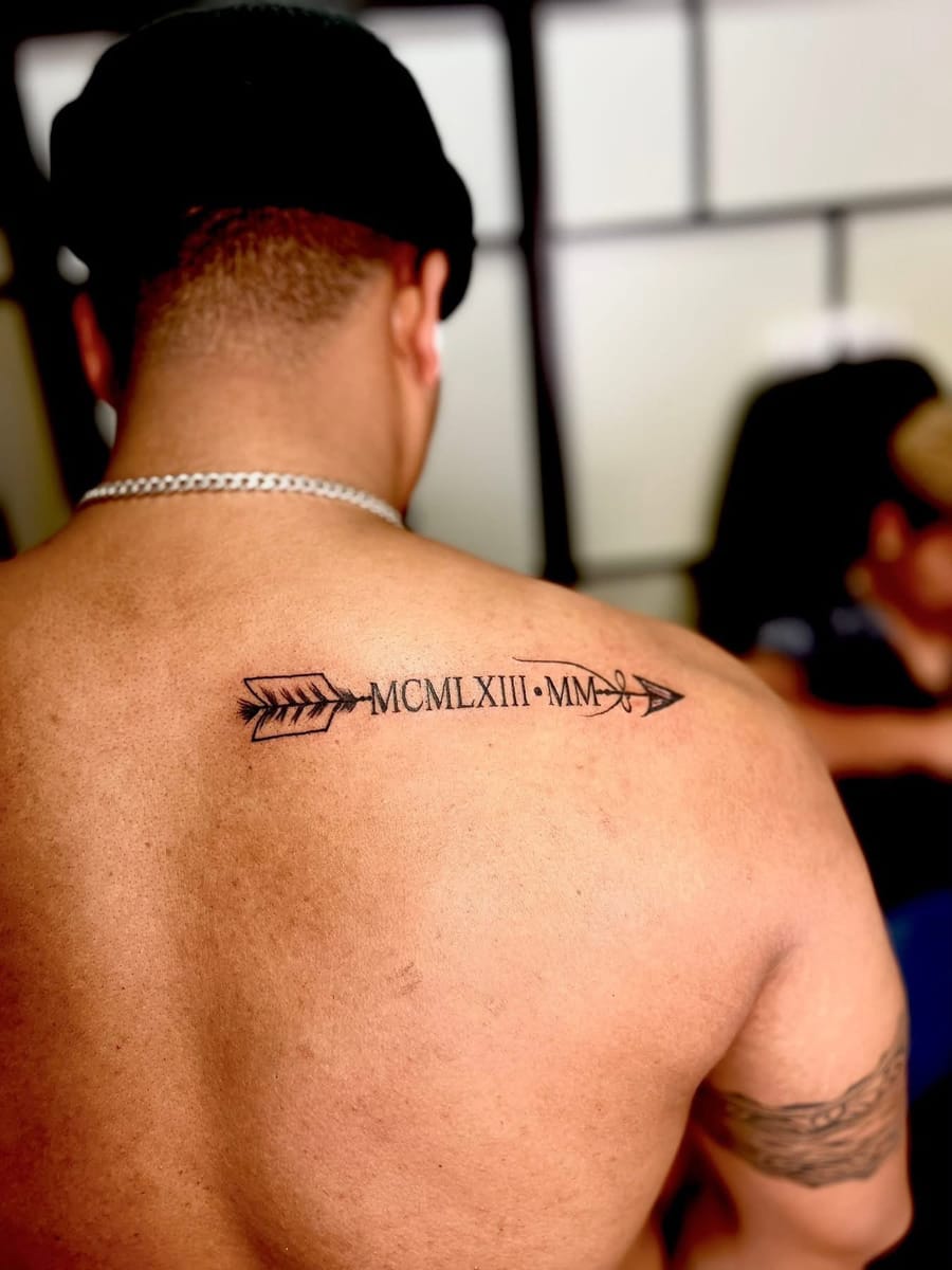 Roman numeral arrow tattoo